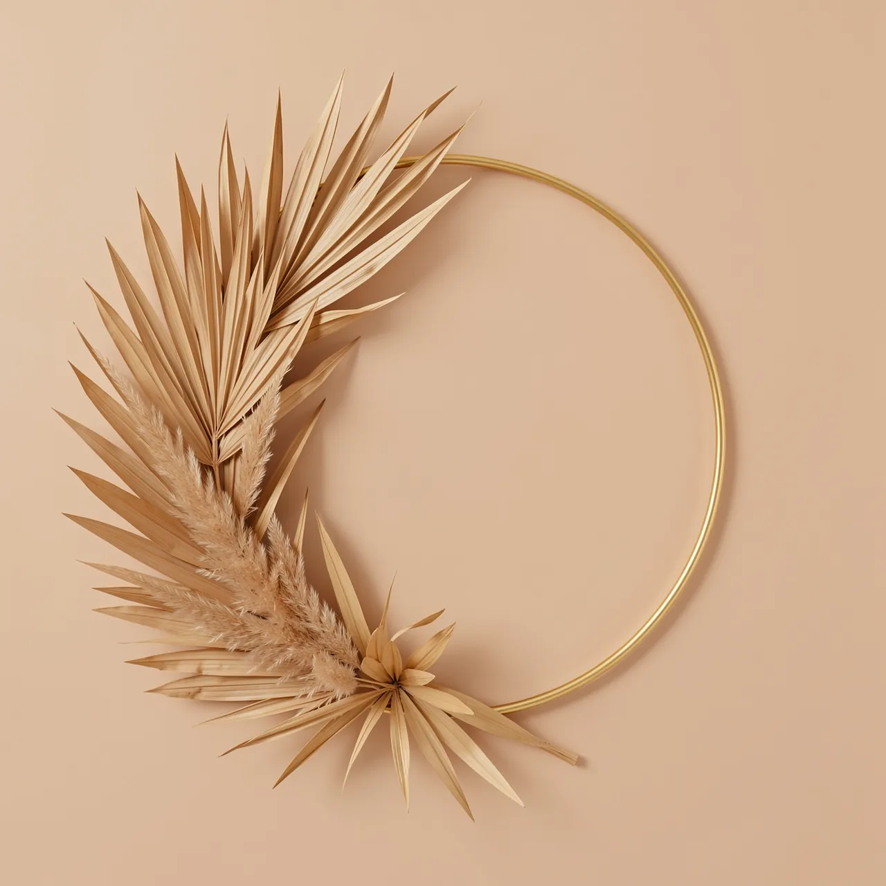 A thin gold hoop wreath adorned with dried palm leaves and pampas grass against a warm beige background