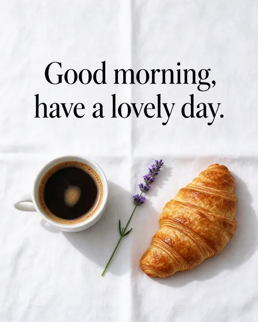 Flat lay of coffee, croissant and lavender on a white linen cloth with the text "Good morning, have a lovely day."