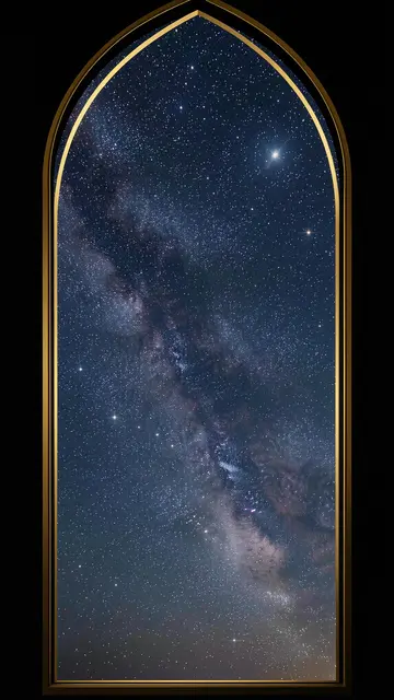 Milky Way starry night sky viewed through a tall gold-edged pointed gothic arch frame