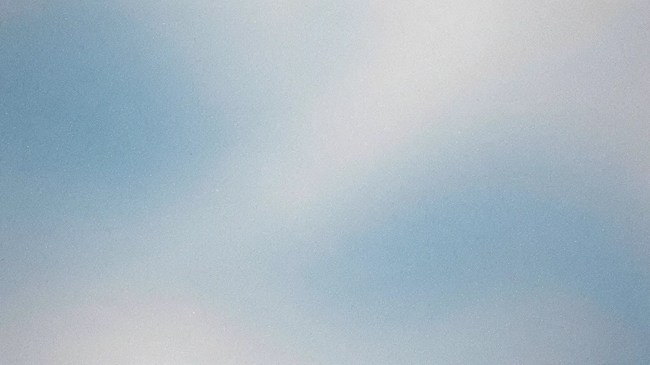 A soft grainy gradient blending ice blue and pale silver hues with subtle speckled noise.