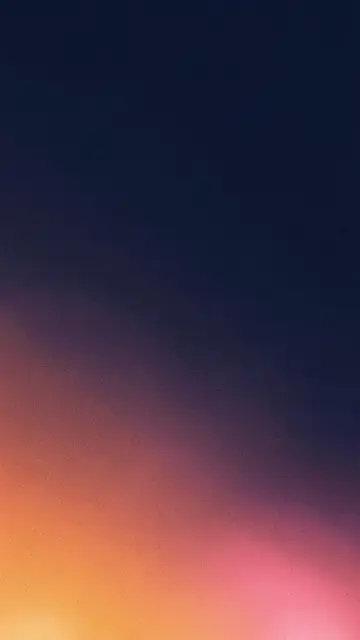 Vertical grainy gradient wallpaper with warm tangerine and pink light blooming from the lower corner into deep navy