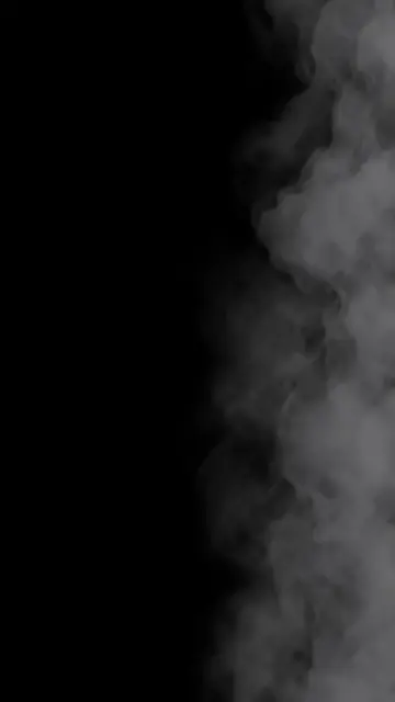 Soft gray mist and smoke drift in from the right edge of a solid pure black frame