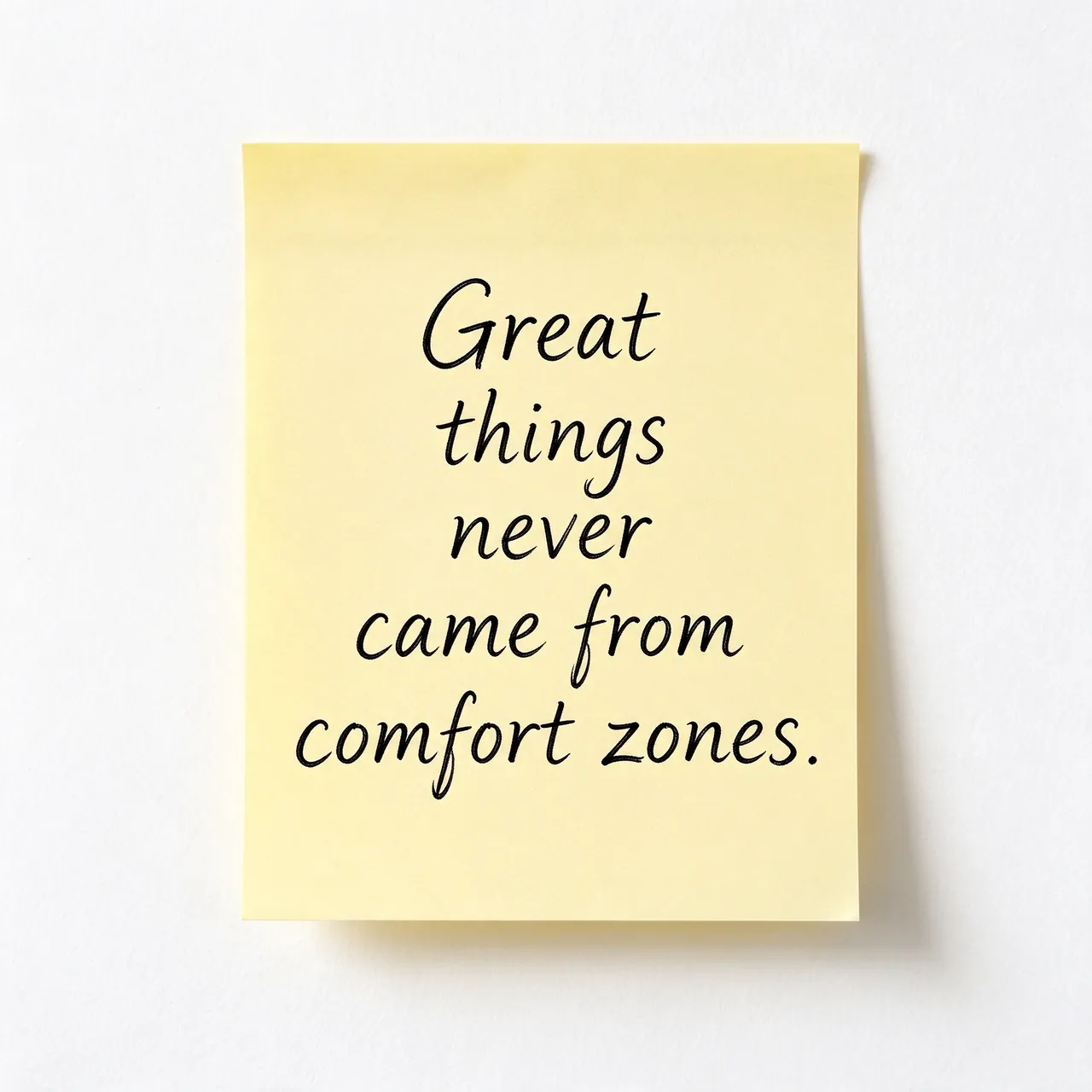 A yellow sticky note on a white wall displays the quote "Great things never came from comfort zones." in black
