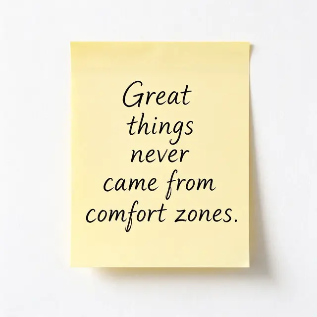 A yellow sticky note on a white wall displays the quote "Great things never came from comfort zones." in black