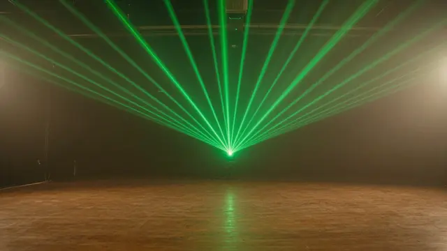 Fanning green laser beams cut through hazy air above an empty polished wooden dance floor
