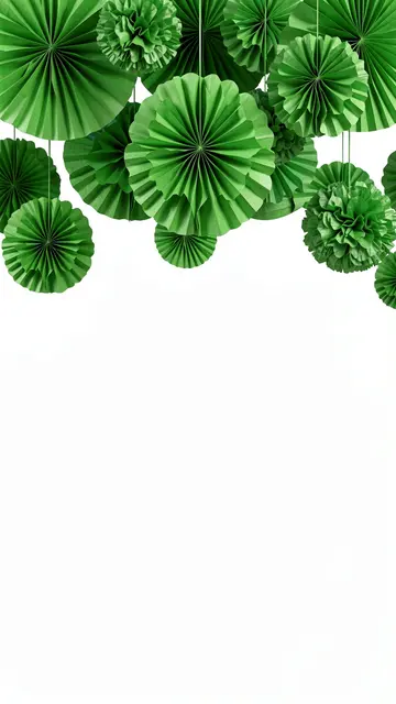 Hanging green pleated paper fans and pom-poms occupy the top edge above empty white copy space