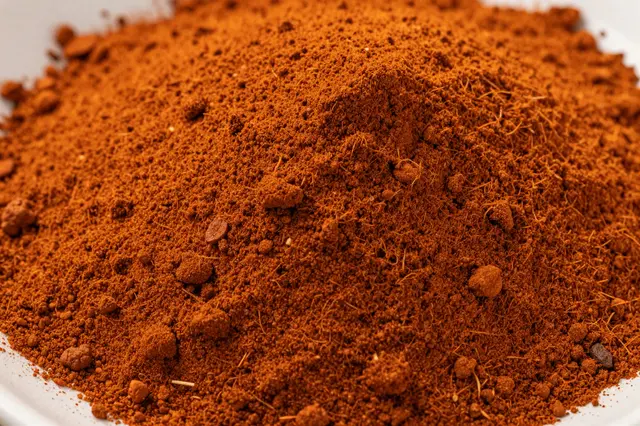 Close-up full frame of textured ground paprika powder in a shallow pile