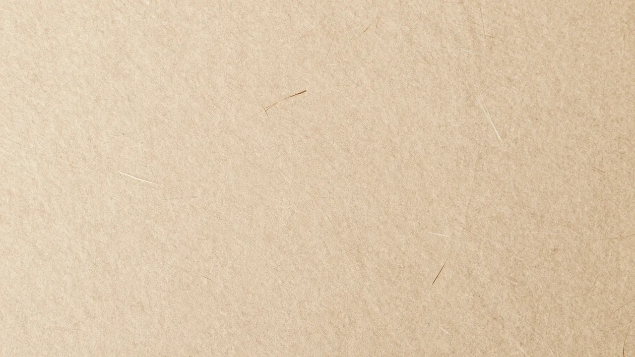 Full frame close-up of natural light brown handmade paper with visible embedded fiber strands