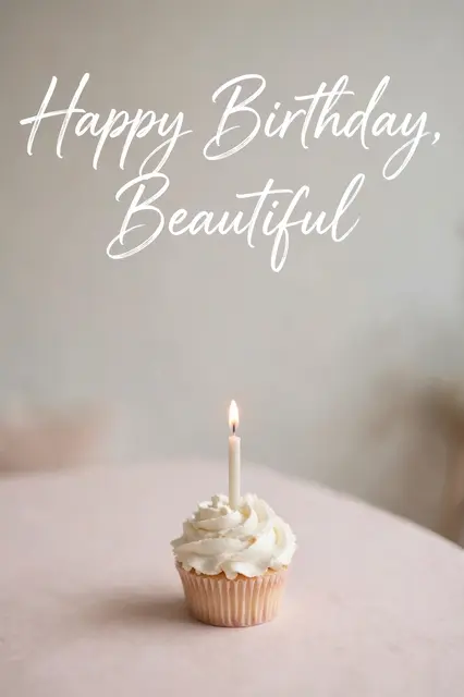 "Happy Birthday, Beautiful" white script lettering above a single frosted cupcake with a lit candle on a pale pink table