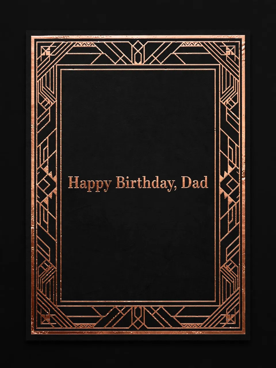 "Happy Birthday, Dad" in copper serif type centered on a black card with an art deco copper geometric border