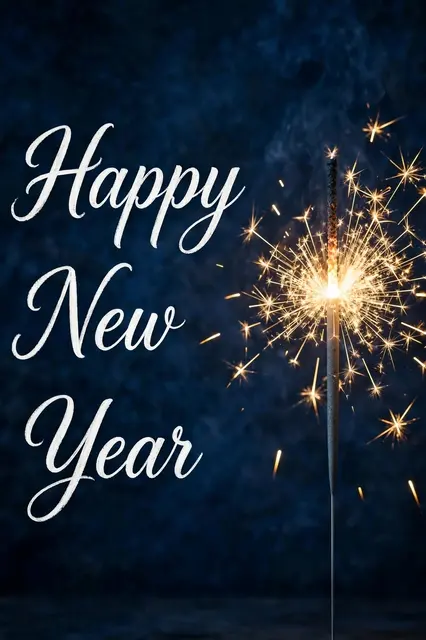 "Happy New Year" white script lettering beside a lit sparkler with golden sparks on a dark blue background