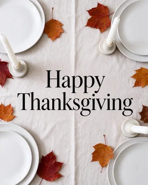 Overhead table setting with autumn leaves, white plates, candles, and centered "Happy Thanksgiving" text on linen.