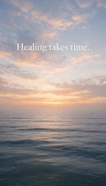 Calm sunrise ocean horizon with soft white serif text reading "Healing takes time."