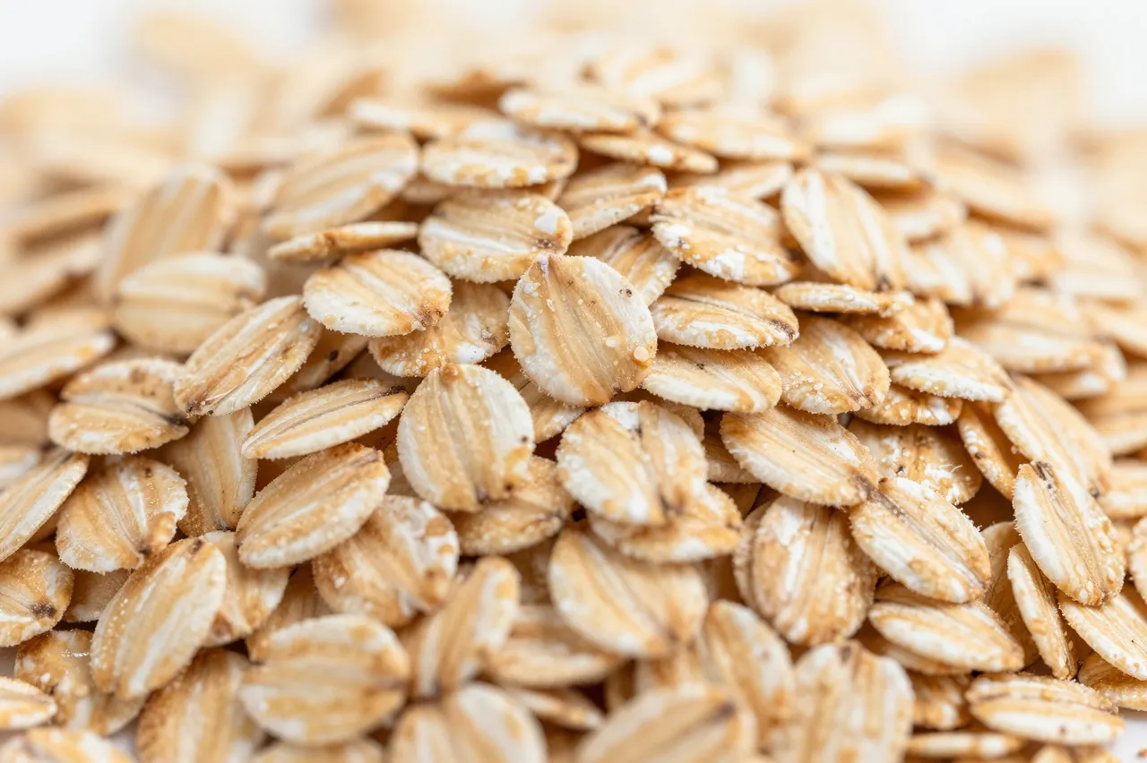 Close-up view of a heap of rolled oats lit by soft warm morning light