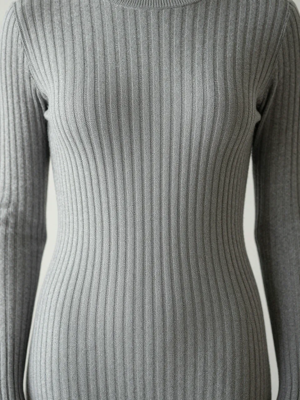 Close-up of a heather gray vertical ribbed knit sweater shown in soft even light