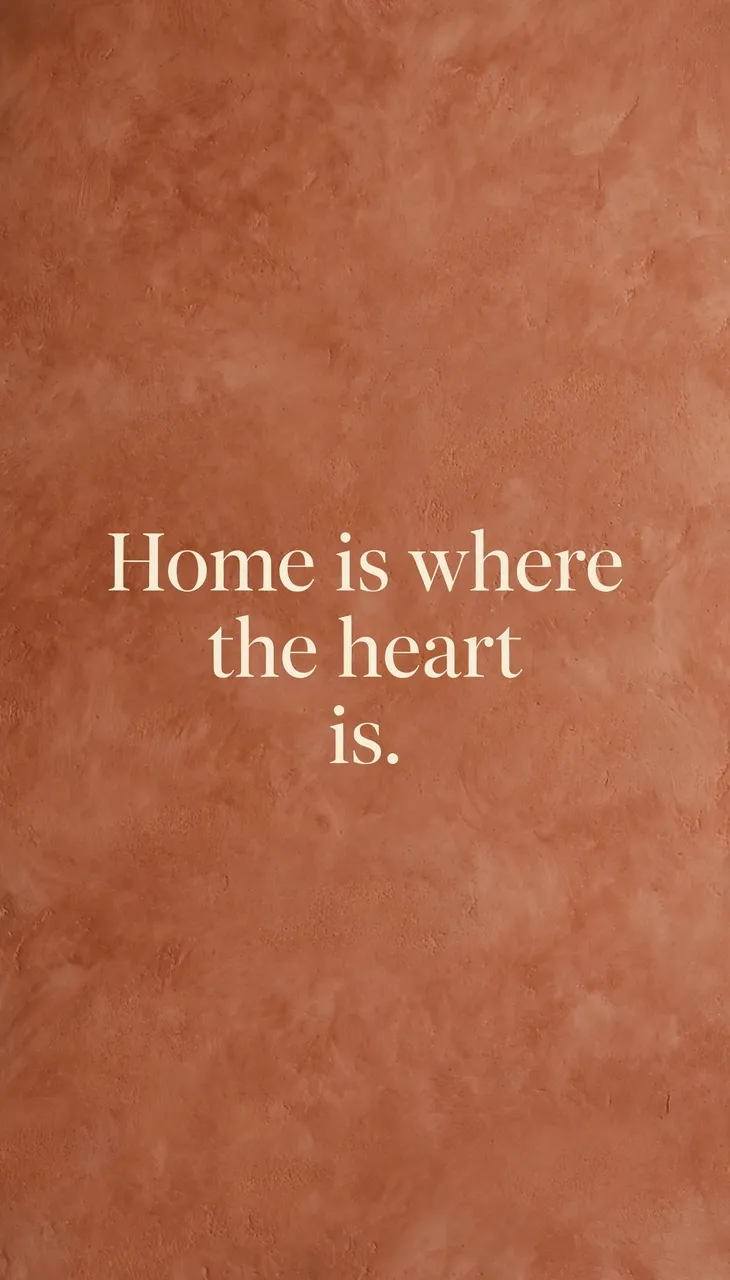 Cream serif text reading "Home is where the heart is." centered on a warm textured terracotta background.