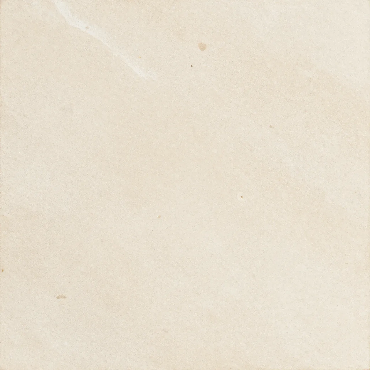 Full frame top view of a flat honed ivory travertine stone surface with soft cloudy mottling