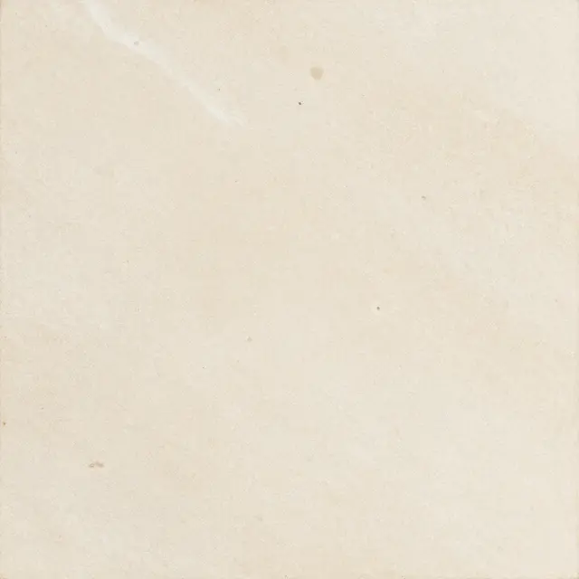 Full frame top view of a flat honed ivory travertine stone surface with soft cloudy mottling