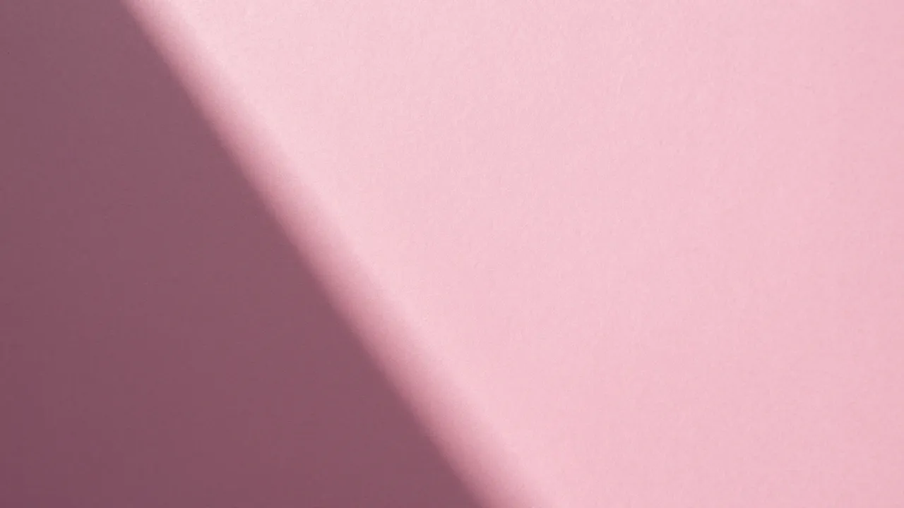 Textured hot pink paper backdrop with a soft crisp diagonal gradient shadow across the frame