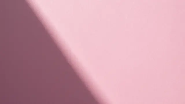 Textured hot pink paper backdrop with a soft crisp diagonal gradient shadow across the frame