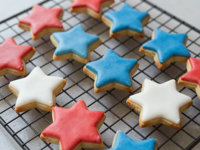 Red, white and blue star-shaped iced shortbread cookies rest on a black wire cooling rack.