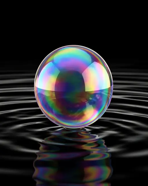 A glossy iridescent soap bubble rests just above rippled black water with a matching reflective surface.