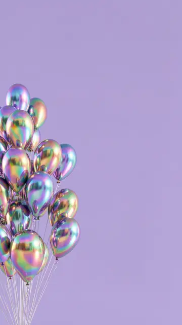 Bunch of iridescent metallic balloons rises against a solid lavender background with empty copy space.