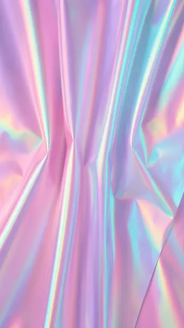 Vertical frame of soft pleated iridescent film catching shifting pink and cyan light