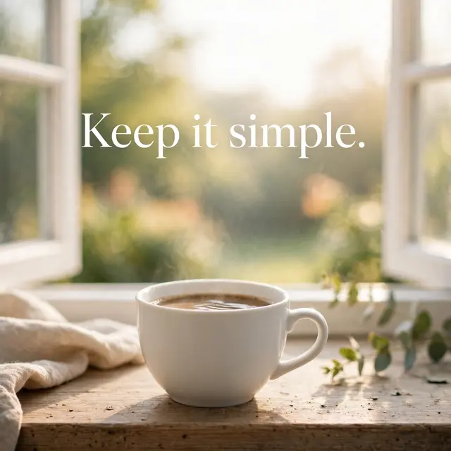 A steaming white coffee cup rests on a sunny wooden windowsill with the text "Keep it simple." over soft morning light.