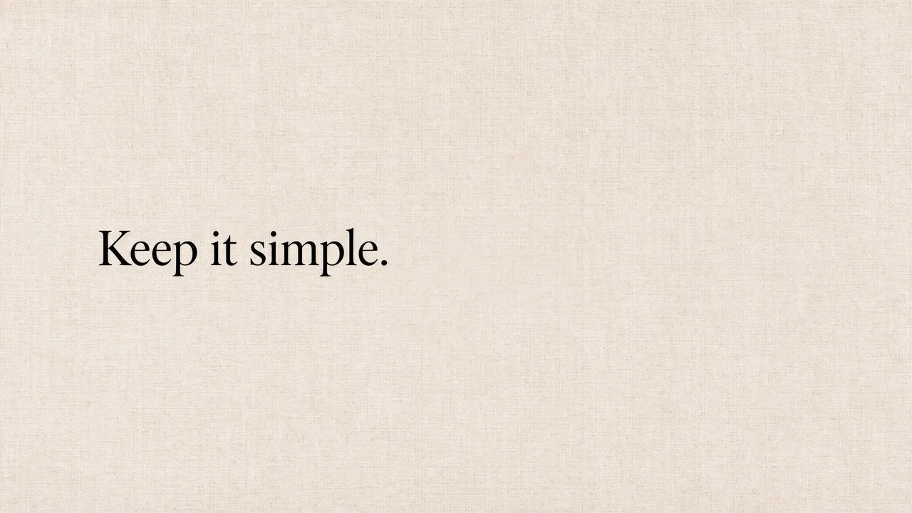 The text "Keep it simple." in black serif type sits left-aligned on a warm beige linen textured desktop wallpaper.