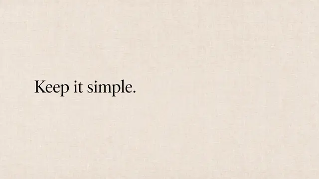 The text "Keep it simple." in black serif type sits left-aligned on a warm beige linen textured desktop wallpaper.