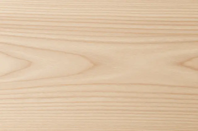 Close-up view of smooth pale white oak wood grain with natural flowing pattern lines