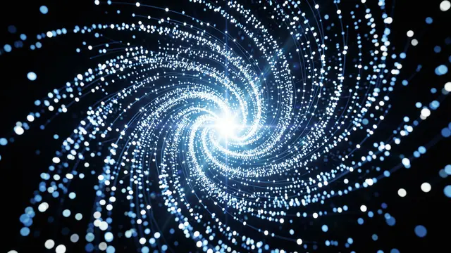 A swirling spiral of glowing blue and white light particles converges on a bright central point against black