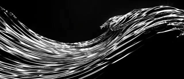 A flowing ultrawide liquid chrome wave with bright highlights curves across a solid black background.