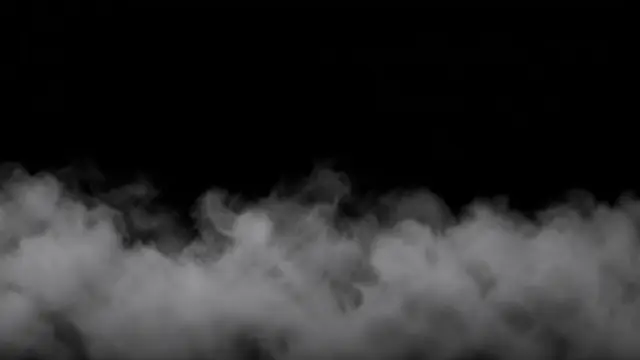 Soft wispy white fog rolls across the lower third of a solid pure black background
