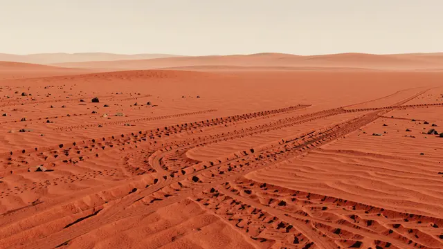Curving rover tire tracks stretch across red sandy Martian terrain under a pale hazy sky