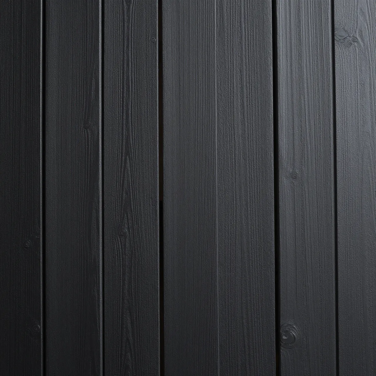 Full frame top view of matte black stained vertical wood planks with visible grain and narrow gaps