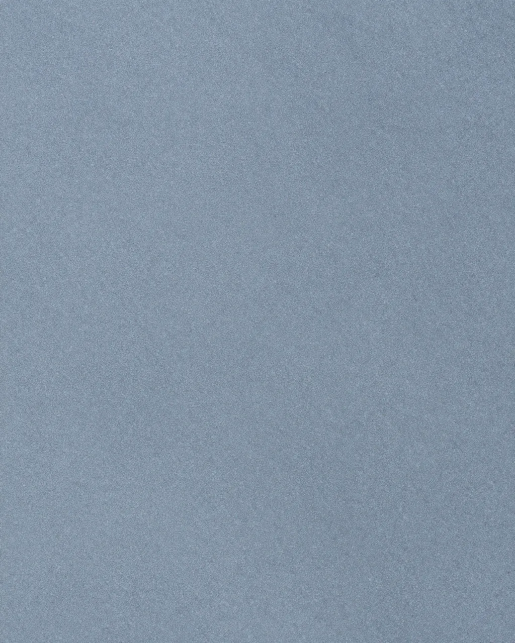 Full frame close-up of a smooth matte blue-gray bluestone surface with even flat lighting
