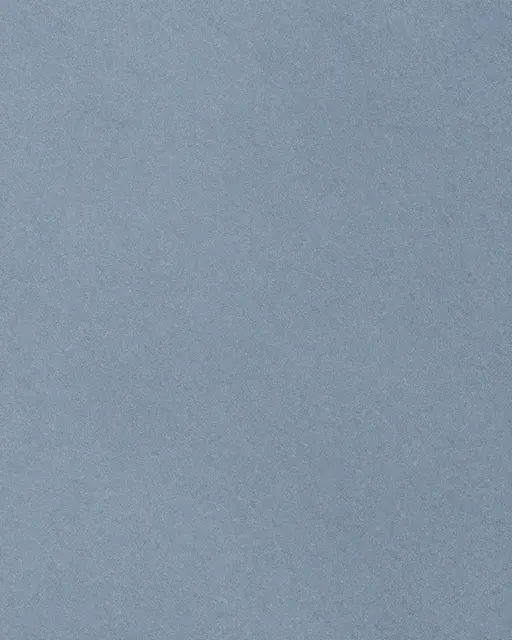 Full frame close-up of a smooth matte blue-gray bluestone surface with even flat lighting