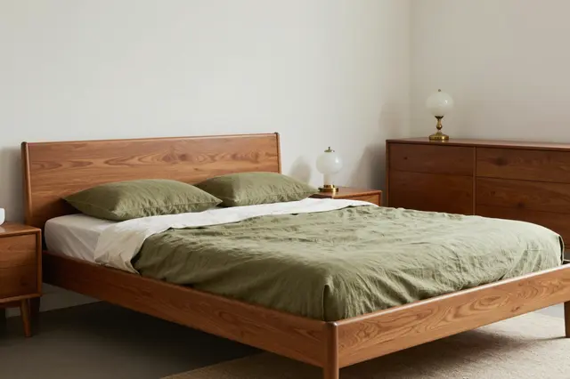 Minimalist mid-century modern bedroom with teak bed, olive linen bedding, and opal glass lamps