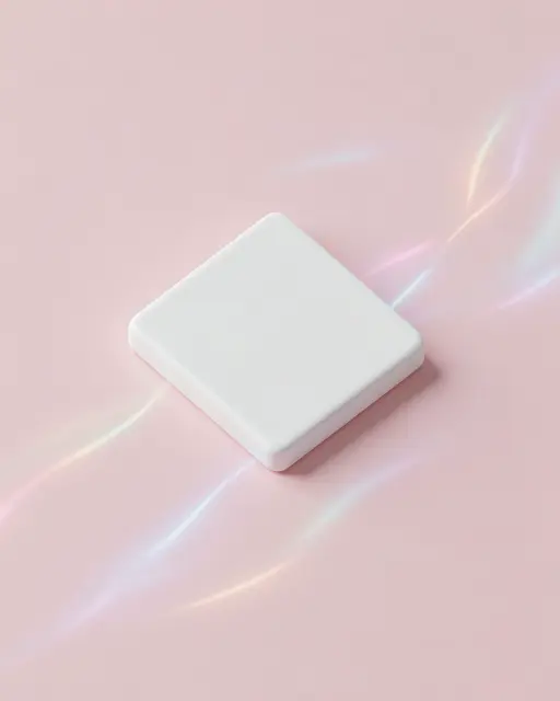 Smooth white square ceramic chip rests on a pale pink surface with iridescent glowing light trails