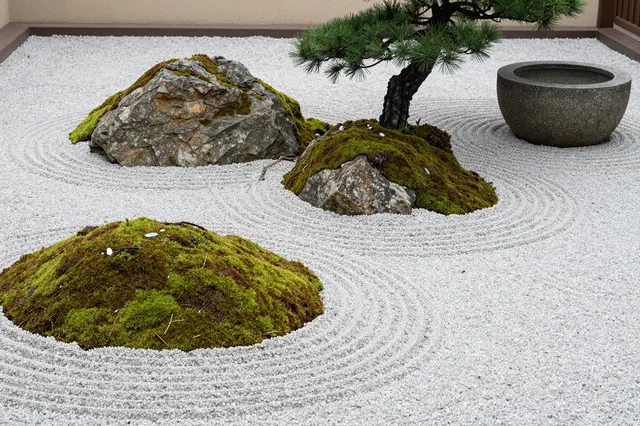 A Japanese zen garden with raked pale gravel, mossy boulders, a black pine, and a stone water basin