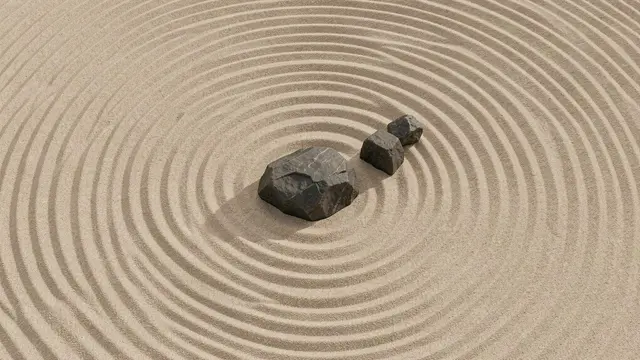 Top-down view of a raked minimalist zen garden with three dark stones set in beige sand