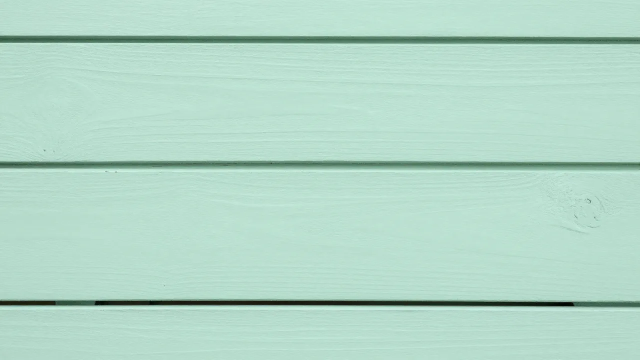 Full frame close-up of horizontal mint green painted wood planks with subtle grain and soft even lighting