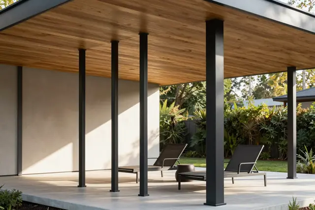 Covered modern porch with slatted cedar ceiling, black steel posts and lounge chairs in warm morning sunlight