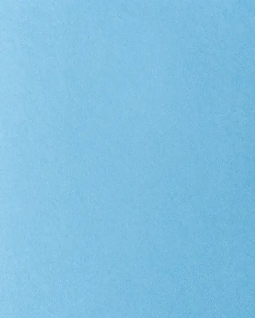 Full frame close-up of smooth light blue fibrous construction paper with even flat lighting