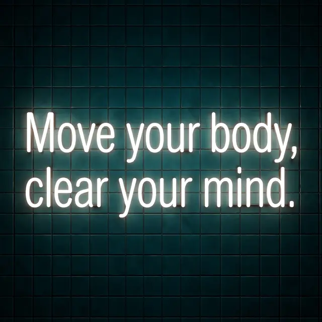 Glowing white neon sign reading "Move your body, clear your mind." mounted on a dark teal tiled wall
