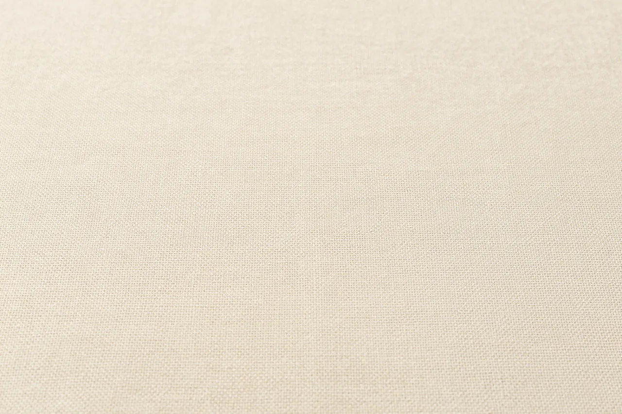 Close up of soft woven natural beige linen fabric surface showing fine weave details
