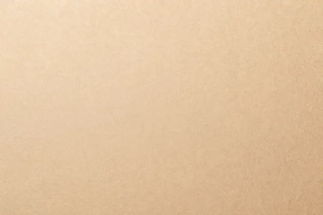 Flat continuous light brown kraft paper surface with subtle grain texture