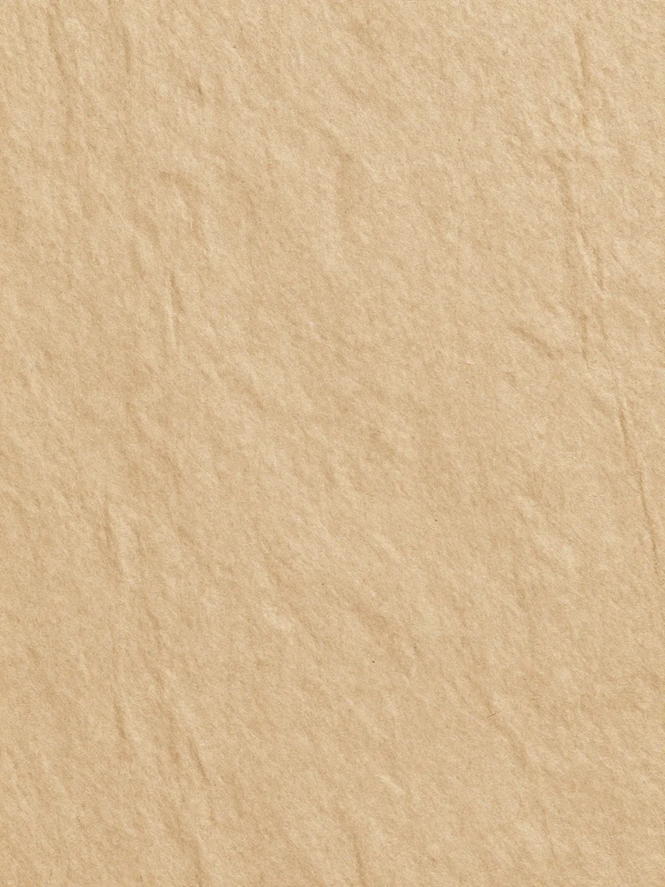 Full frame close-up of coarse natural tan bark-fiber paper with subtle surface streaks